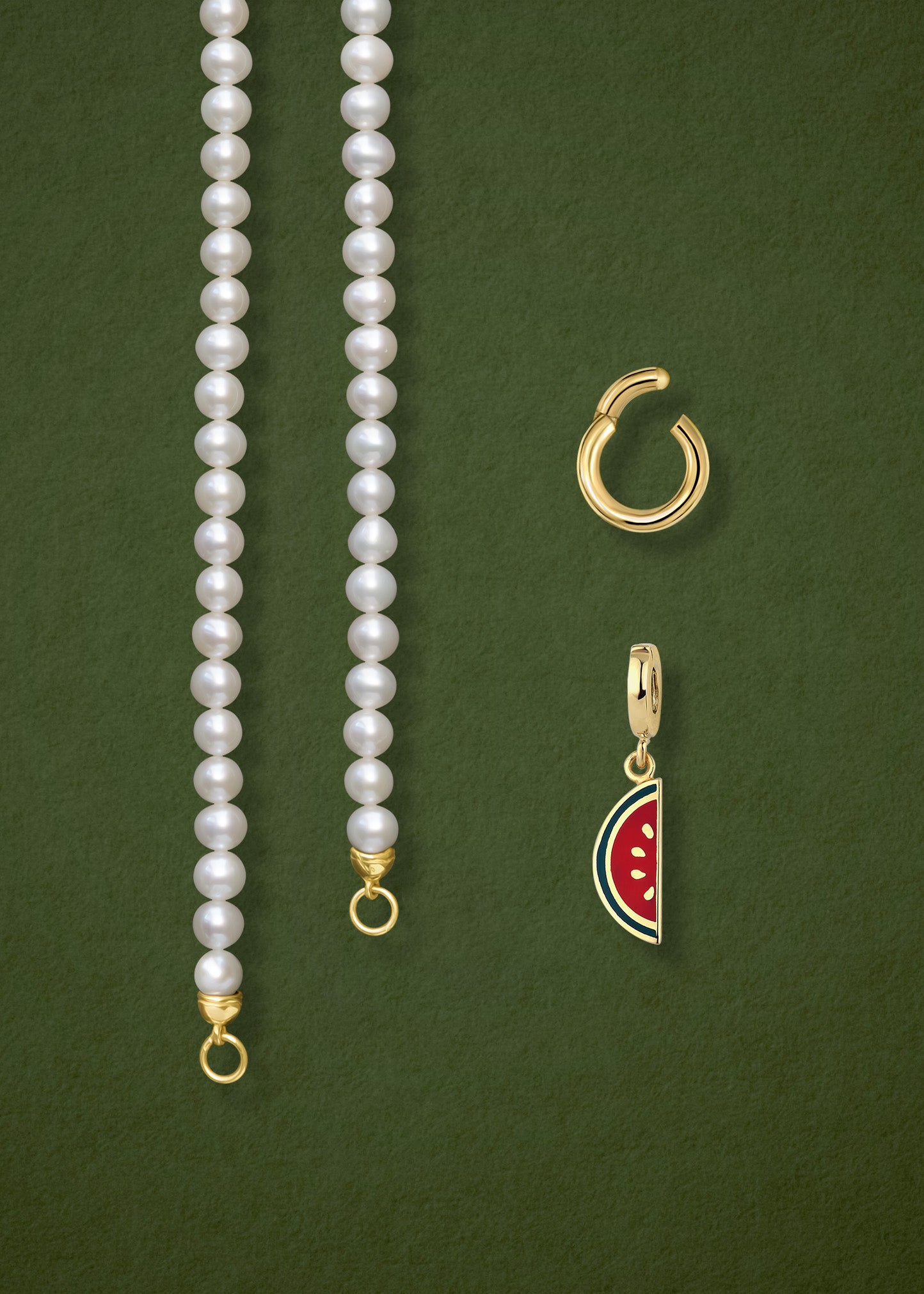 Close-up of the separated Lustrous Pearl Watermelon Wonder Charm Necklace components: pearl necklace, golden link charm holder, and watermelon wonder charm in 14K solid gold by whywhy NYC.