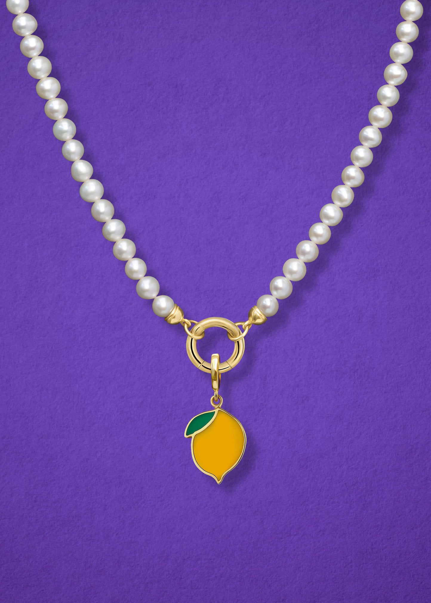 Close-up of the Lustrous Pearl Zesty Lemon Charm Necklace, featuring freshwater pearls, a golden link charm holder, and a zesty lemon charm in 14K solid gold by whywhy NYC.