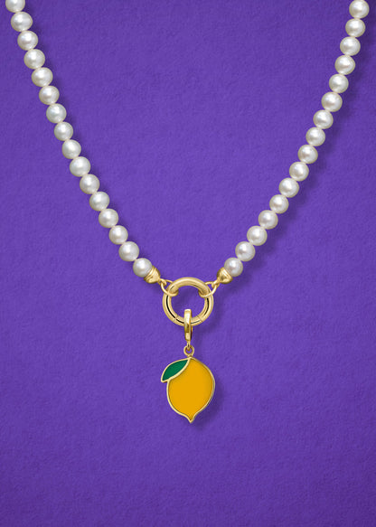 Close-up of the Lustrous Pearl Zesty Lemon Charm Necklace, featuring freshwater pearls, a golden link charm holder, and a zesty lemon charm in 14K solid gold by whywhy NYC.