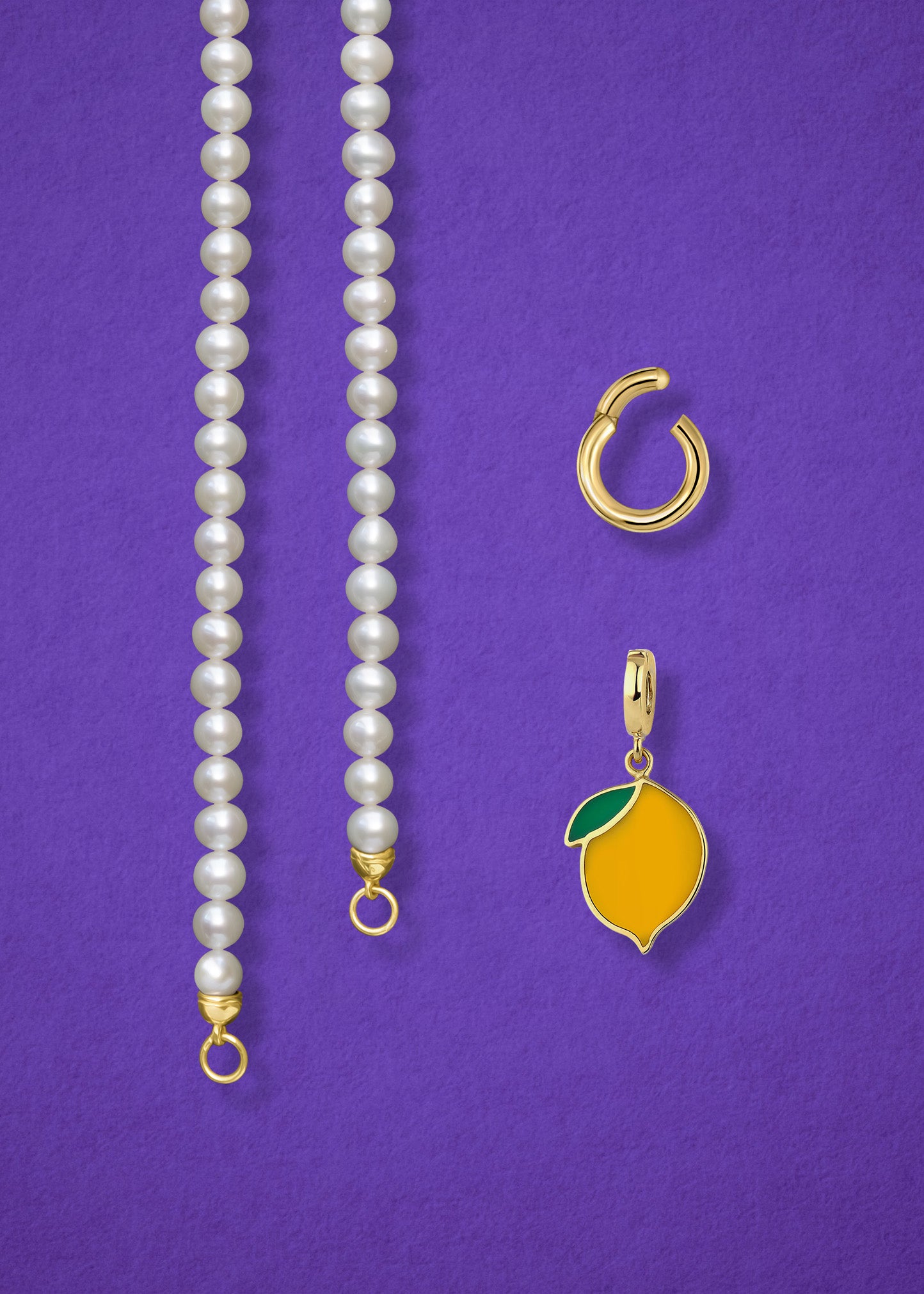 Close-up of the separated Lustrous Pearl Zesty Lemon Charm Necklace components: pearl necklace, golden link charm holder, and zesty lemon charm in 14K solid gold by whywhy NYC.