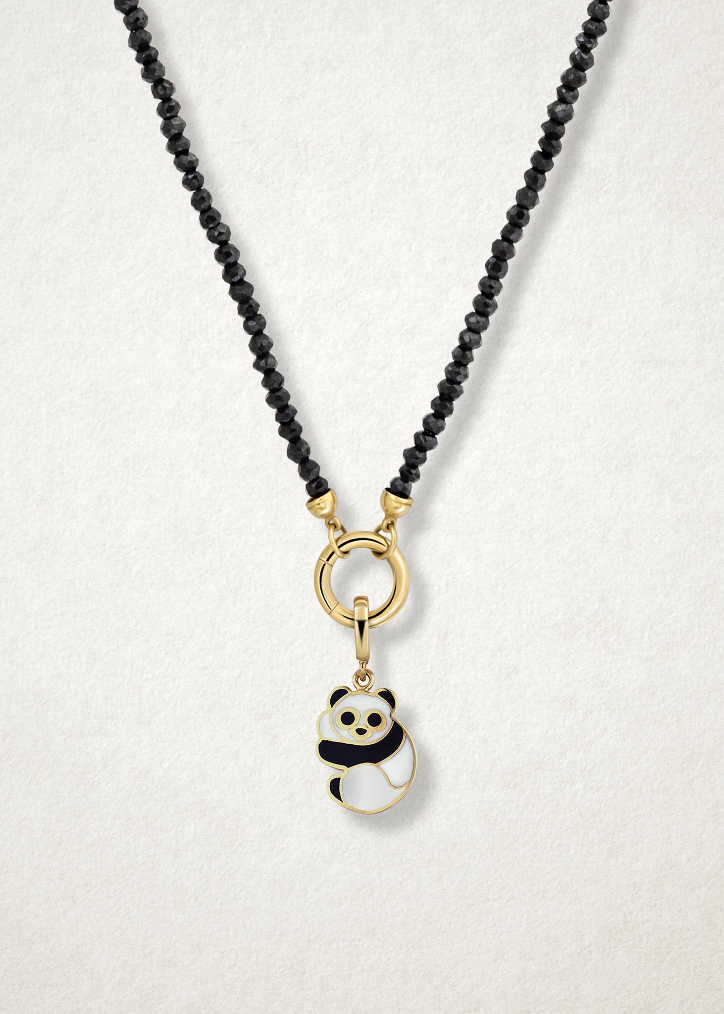 Close-up of the Panda Pals Charm paired with the Noir Elegance Charm Necklace by whywhy NYC, featuring black spinel and 14K solid gold for a bold and playful combination.