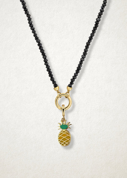Close-up of the Pineapple Paradise Charm paired with the Noir Elegance Charm Necklace by whywhy NYC, featuring black spinel and 14K solid gold for a bold and tropical-inspired design.