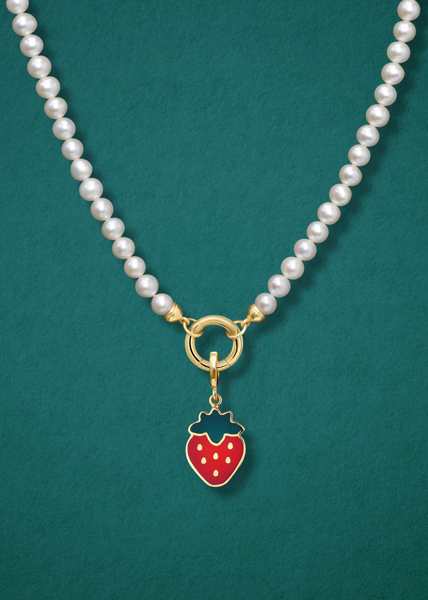 Close-up of the Sweet Strawberry Charm paired with the Lustrous Pearl Charm Necklace by whywhy NYC, featuring 14K solid gold and freshwater pearls for a timeless yet sweet touch.