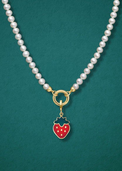 Close-up of the Sweet Strawberry Charm paired with the Lustrous Pearl Charm Necklace by whywhy NYC, featuring 14K solid gold and freshwater pearls for a timeless yet sweet touch.