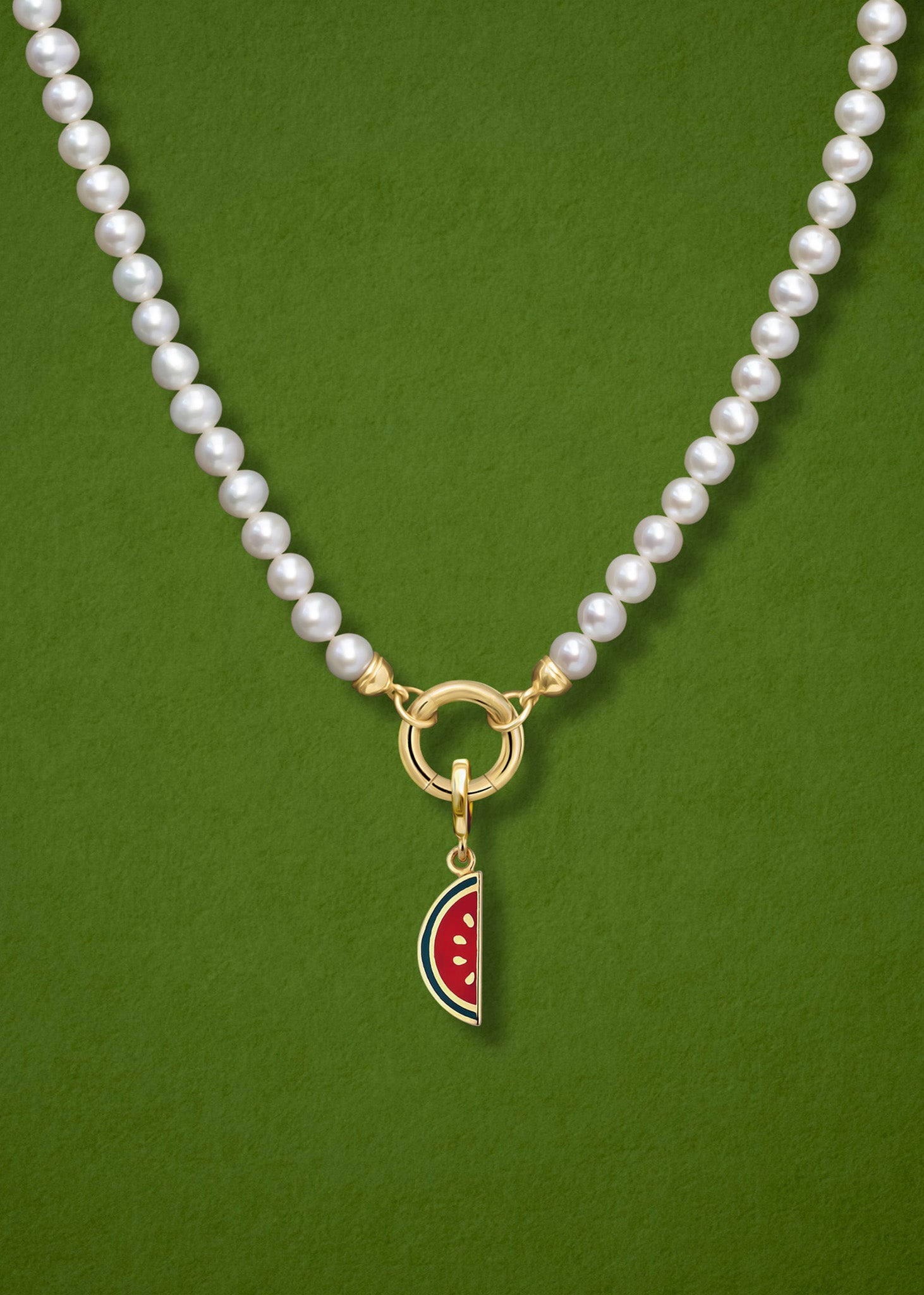 Close-up of the Watermelon Wonder Charm paired with the Lustrous Pearl Charm Necklace by whywhy NYC, featuring 14K solid gold and freshwater pearls for a whimsical yet stylish design.