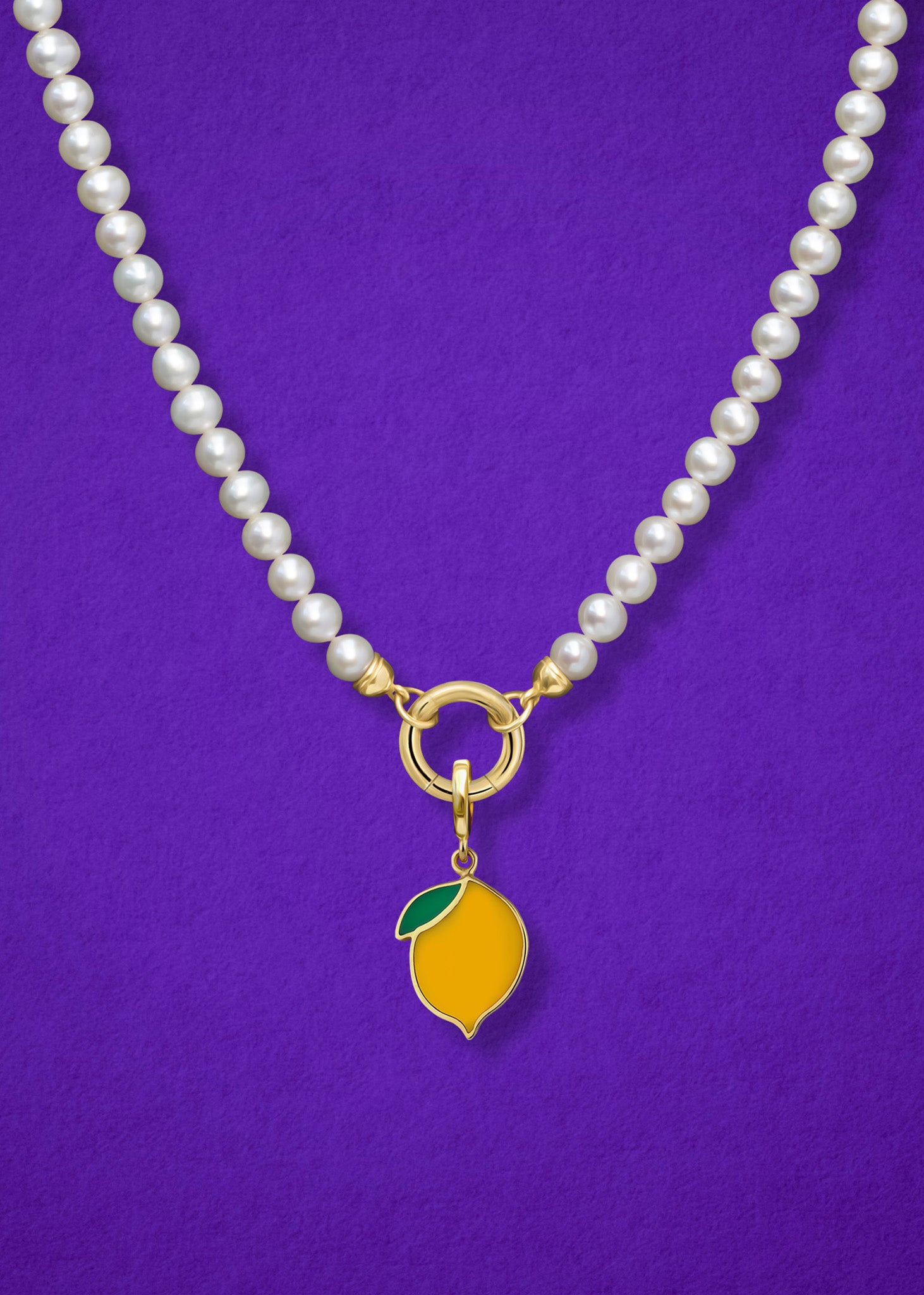 Close-up of the Zesty Lemon Charm paired with the Lustrous Pearl Charm Necklace by whywhy NYC, featuring 14K solid gold and freshwater pearls for a timeless yet playful look.