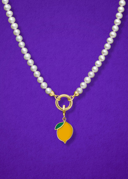 Close-up of the Zesty Lemon Charm paired with the Lustrous Pearl Charm Necklace by whywhy NYC, featuring 14K solid gold and freshwater pearls for a timeless yet playful look.
