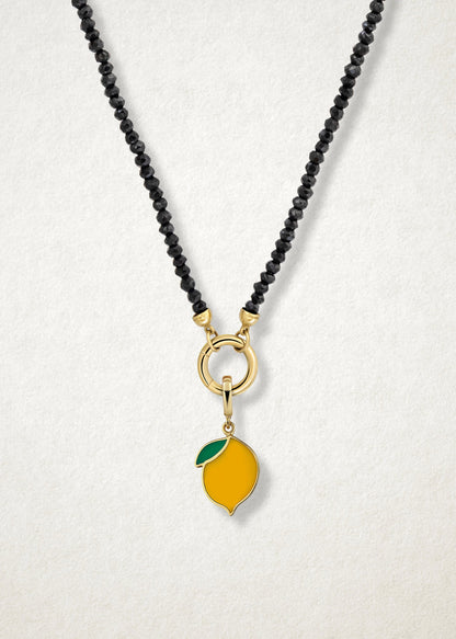 Close-up of the Zesty Lemon Charm paired with the Noir Elegance Charm Necklace by whywhy NYC, featuring black spinel and 14K solid gold for a bold and zesty touch.