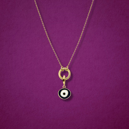 Close-up of the Obsidian Organic Evil Eye Charm with hand-painted enamel on a 14K solid gold cable chain necklace, shown on a magenta background.