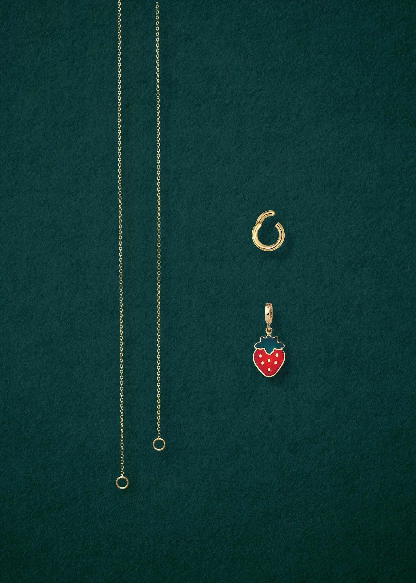 Separated components of the Golden Grace Sweet Strawberry Charm Necklace, including 14K solid gold cable chain, golden charm holder, and sweet strawberry charm with red enamel by whywhy NYC.