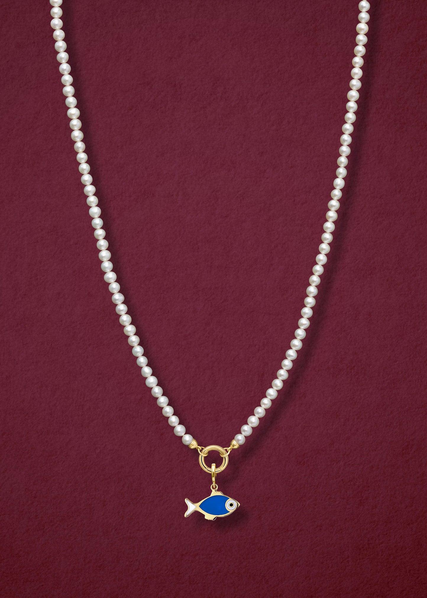 Lustrous Pearl Fishy Wishes Charm Necklace in full view, showcasing pearls, a golden link charm holder, and a fishy wishes charm in 14K solid gold by whywhy NYC.