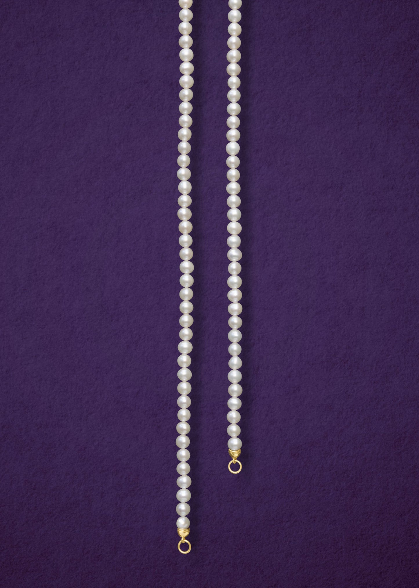 Lustrous Pearl Charm Necklace, a handcrafted 20-inch freshwater pearl necklace with a 14K solid gold clasp by whywhy NYC.
