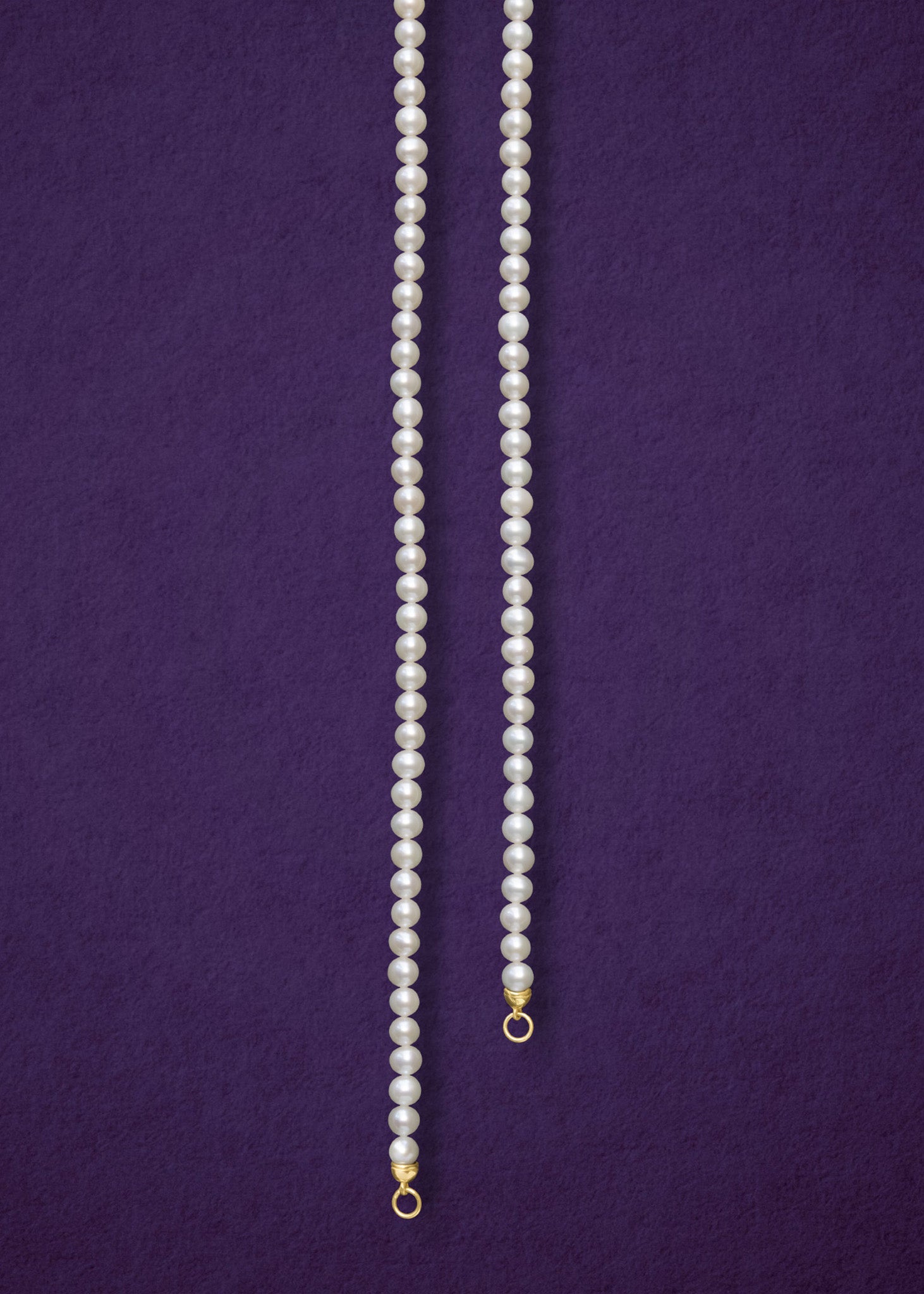 Lustrous Pearl Charm Necklace, a handcrafted 20-inch freshwater pearl necklace with a 14K solid gold clasp by whywhy NYC.