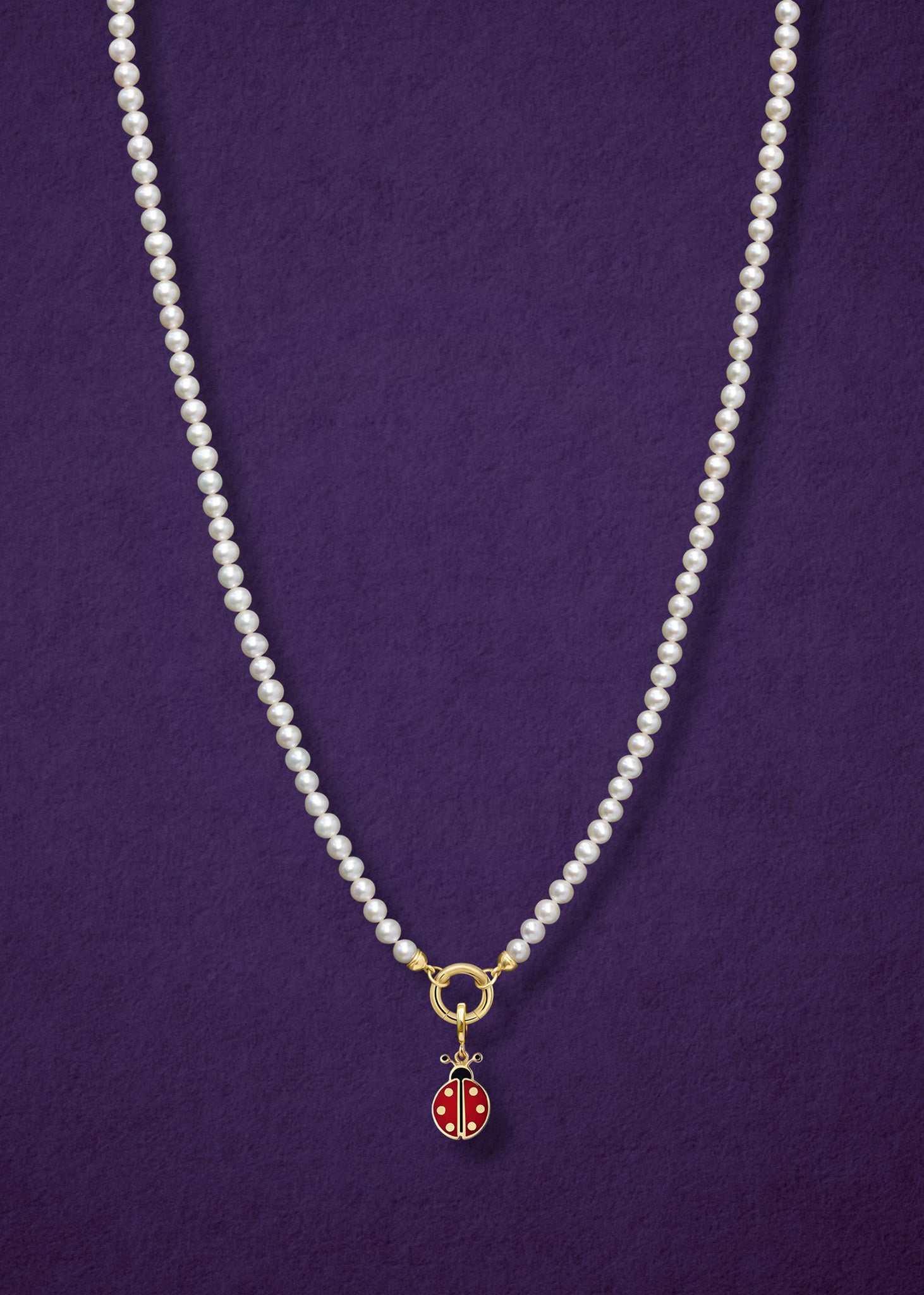 Lustrous Pearl Charm Necklace paired with the Lucky Ladybird Charm by whywhy NYC, featuring 14K solid gold and hand-painted enamel for a playful, elegant look.