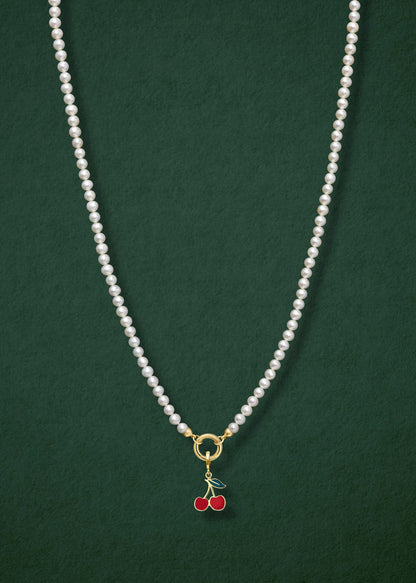 Lustrous Pearl Cherry on Top Charm Necklace in full view, showcasing pearls, a golden link charm holder, and a cherry on top charm in 14K solid gold by whywhy NYC.