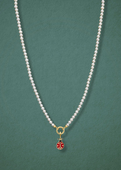 Lustrous Pearl Lucky Ladybird Charm Necklace in full view, showcasing pearls, a golden link charm holder, and a lucky ladybird charm in 14K solid gold by whywhy NYC.