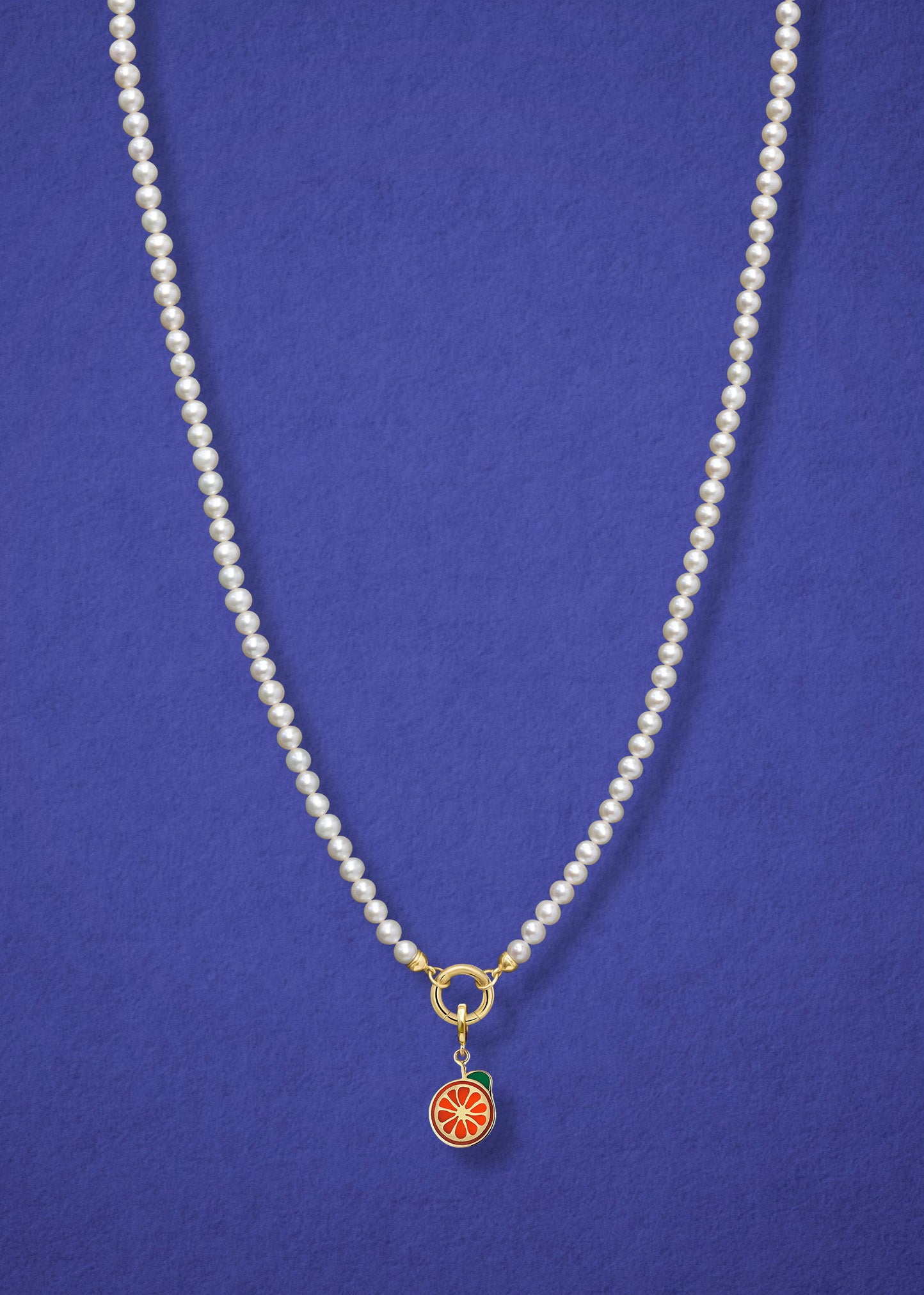 Lustrous Pearl Orange Crush Charm Necklace in full view, showcasing pearls, a golden link charm holder, and an orange crush charm in 14K solid gold by whywhy NYC.