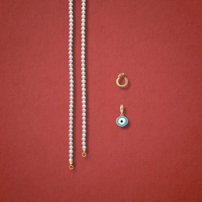 Sky Organic Evil Eye Charm, Golden Link Charm Holder, and Lustrous Pearl necklace are displayed separately on a red background to showcase styling options.