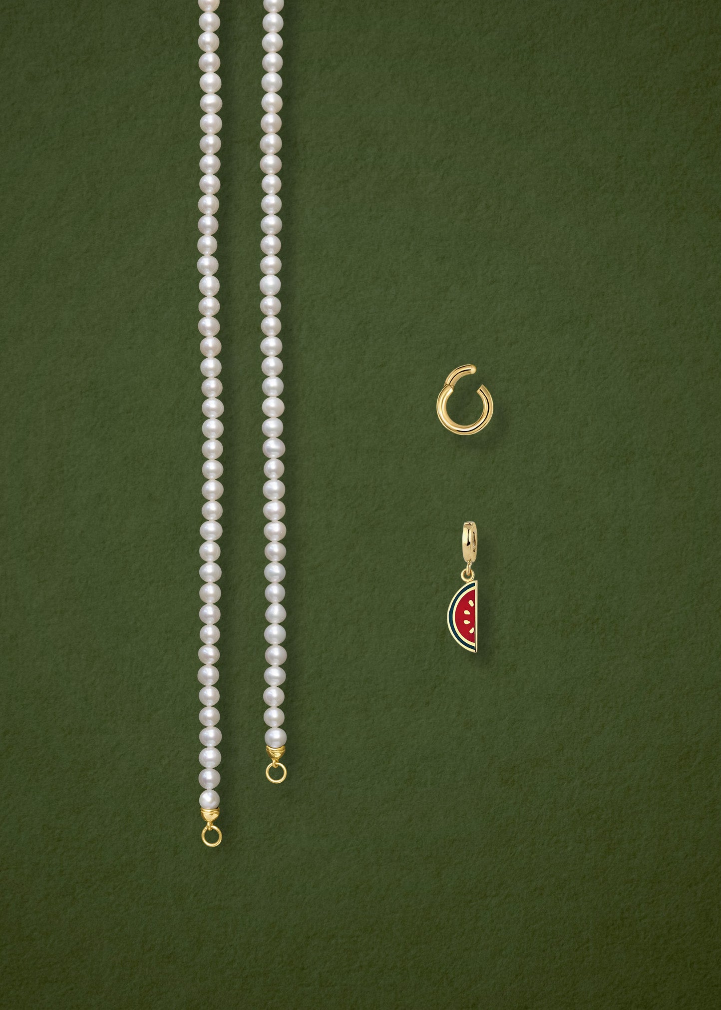 Separated components of the Lustrous Pearl Watermelon Wonder Charm Necklace, including pearl necklace, charm holder, and watermelon wonder charm in 14K solid gold by whywhy NYC.