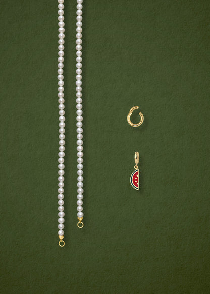 Separated components of the Lustrous Pearl Watermelon Wonder Charm Necklace, including pearl necklace, charm holder, and watermelon wonder charm in 14K solid gold by whywhy NYC.