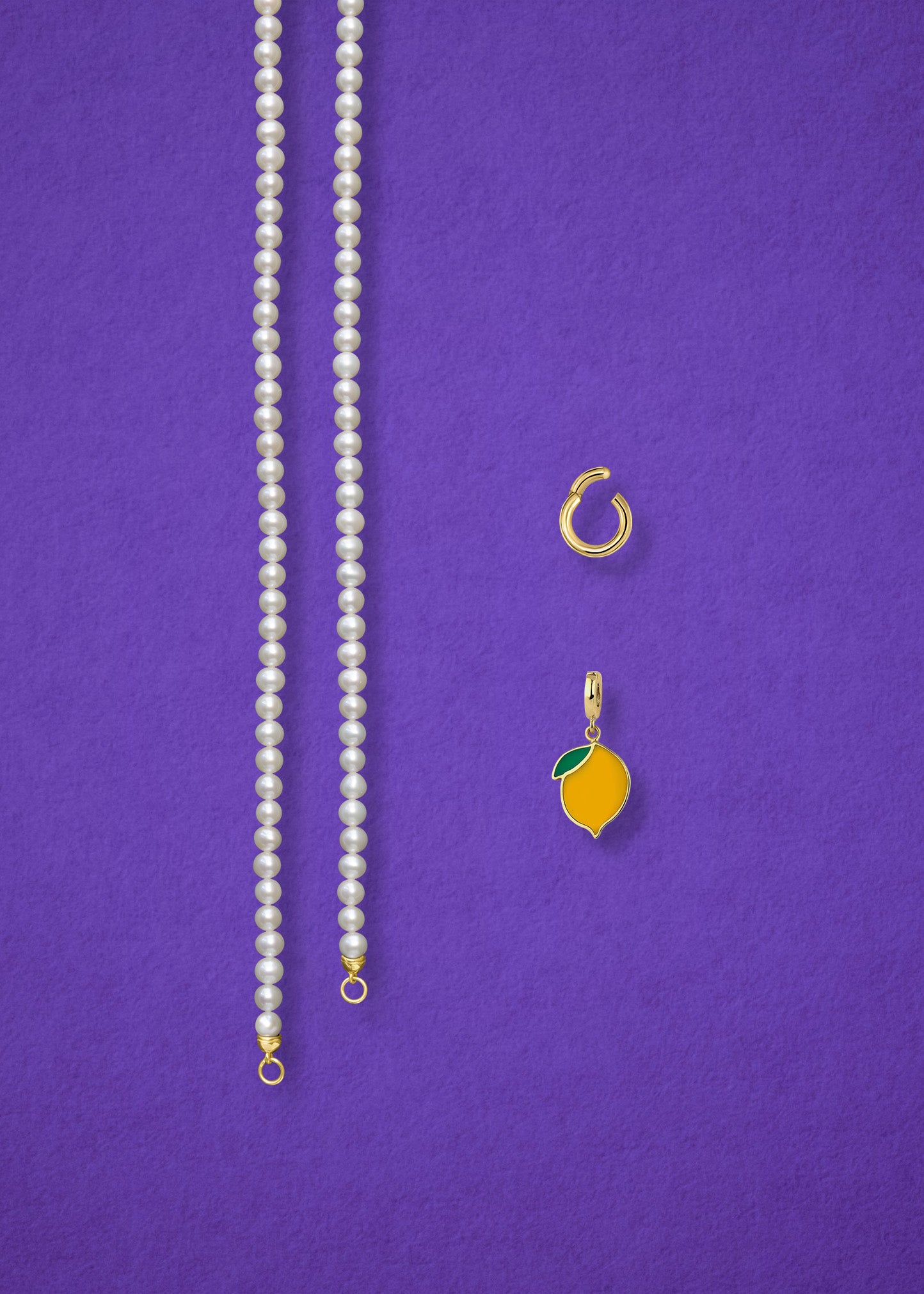 Separated components of the Lustrous Pearl Zesty Lemon Charm Necklace, including pearl necklace, charm holder, and zesty lemon charm in 14K solid gold by whywhy NYC.