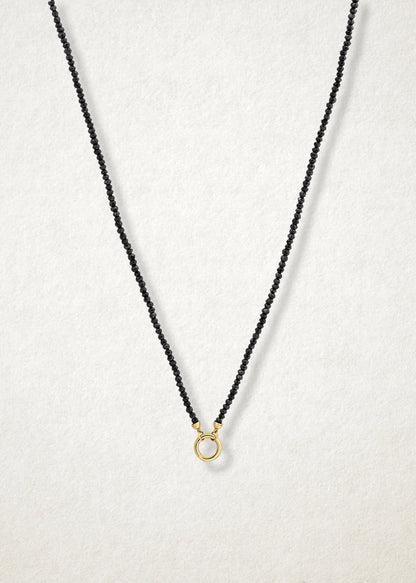 Noir Elegance Charm Necklace paired with a 14K solid gold charm holder by whywhy NYC, perfect for bold and refined charm designs.