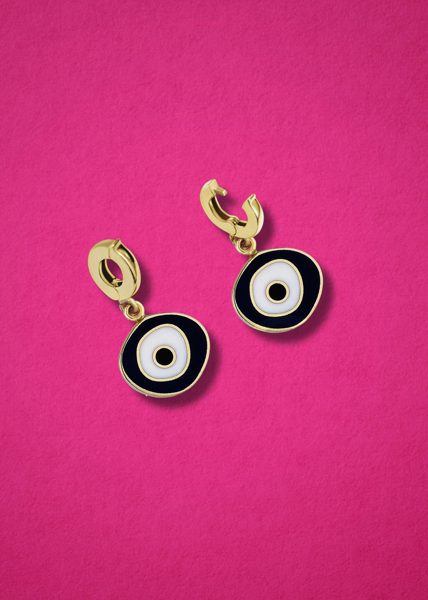 Clip-on bail of the 14K solid gold Obsidian Organic Evil Eye Charm shown in open and closed view on a magenta background.