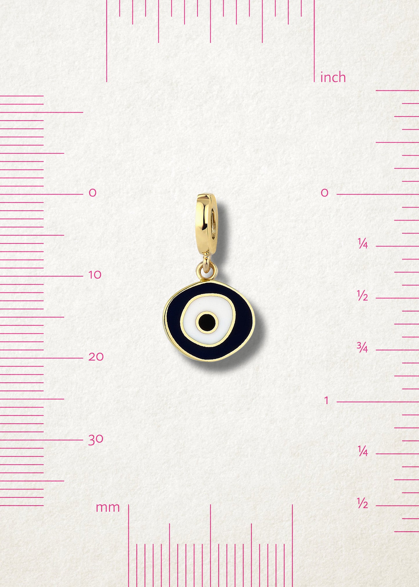 Obsidian Organic Evil Eye Charm with black and white enamel displayed beside measurement markers on a soft light background to show its size.