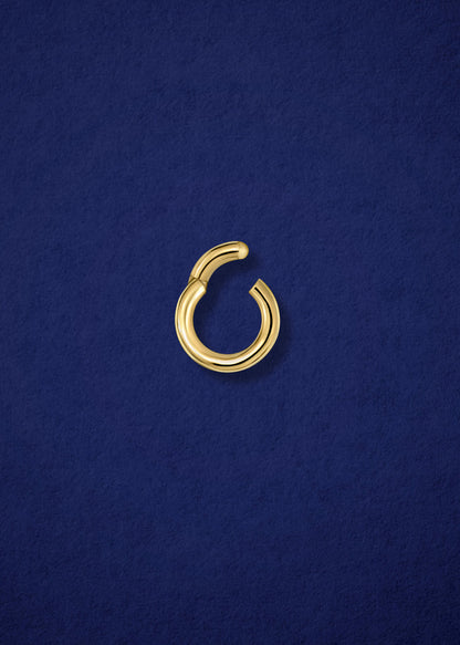 Open 14K solid gold charm holder by whywhy NYC, showcasing its sleek design and secure functionality.