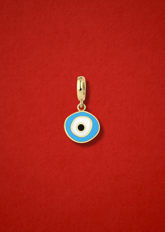 Sky Organic Evil Eye clip-on charm crafted in 14K solid gold with hand-painted sky blue, white, and black enamel detailing, shown on a red background.