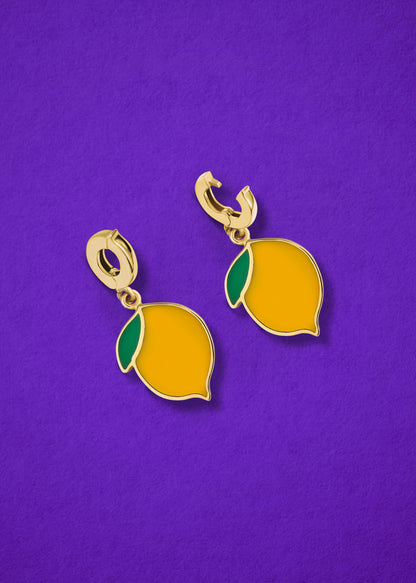 Zesty Lemon Charm showing both open and closed views of the 14K solid gold clip, with vibrant yellow enamel, displayed on a purple background.